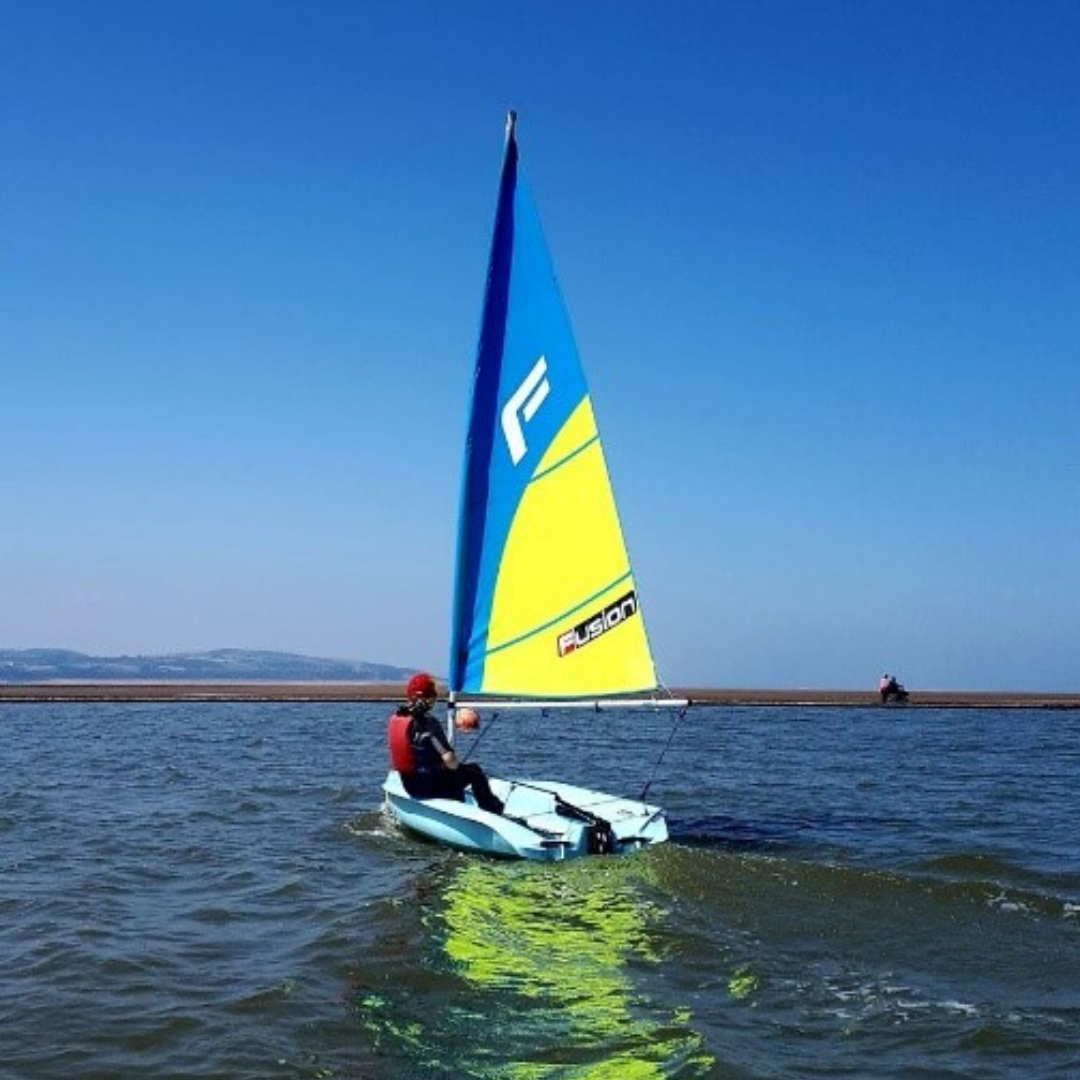 fusion sailboat watersport solo sailing blue sky Lady Sailing on Marine Lake